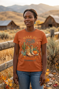 Black woman wearing Walk By Faith Tee in burnt orange on autumn western setting